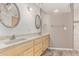 Bright bathroom featuring double sinks, a large mirror, and modern fixtures at 8303 E Monterey Ave, Mesa, AZ 85209