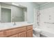 Full bathroom with combined tub and shower, single vanity, and neutral color palette at 8303 E Monterey Ave, Mesa, AZ 85209