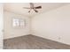 Bright bedroom featuring wood-look flooring, plantation shutters, and neutral color scheme at 8303 E Monterey Ave, Mesa, AZ 85209