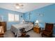 Tranquil bedroom featuring blue walls, shuttered windows, and neutral carpeting, creating a relaxing retreat at 8303 E Monterey Ave, Mesa, AZ 85209