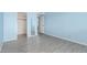 A bright bedroom with light blue walls and wood-look flooring with a view into the closet at 8303 E Monterey Ave, Mesa, AZ 85209