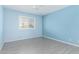 A bright bedroom with light blue walls and wood-look flooring with a ceiling fan overhead at 8303 E Monterey Ave, Mesa, AZ 85209