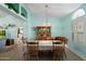 Bright dining room with a large table, wooden chairs, a built-in hutch, and ample natural light streaming through the windows at 8303 E Monterey Ave, Mesa, AZ 85209
