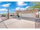 Paver driveway leads to a two-car garage, complemented by desert landscaping and a blue sky at 8303 E Monterey Ave, Mesa, AZ 85209
