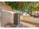 Exterior view of the property's AC unit near a decorative tree with fruit at 8303 E Monterey Ave, Mesa, AZ 85209
