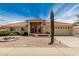 Charming single-story home with a red tile roof, desert landscaping, and an attached two car garage at 8303 E Monterey Ave, Mesa, AZ 85209