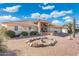 Inviting single-story home with desert landscaping, a rock garden, covered entrance and attached garage at 8303 E Monterey Ave, Mesa, AZ 85209