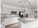 Modern kitchen with white cabinetry, stainless steel appliances, and a functional center island at 8303 E Monterey Ave, Mesa, AZ 85209
