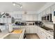 Bright kitchen with stainless steel appliances, marble-style backsplash, and spacious gray countertops at 8303 E Monterey Ave, Mesa, AZ 85209