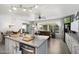 Bright kitchen overlooking an eating area, with granite countertops, stainless steel appliances, and light wood floors at 8303 E Monterey Ave, Mesa, AZ 85209