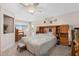 Comfortable main bedroom with carpet, a ceiling fan, and built-in shelving units framing the bed at 8303 E Monterey Ave, Mesa, AZ 85209