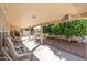 Covered patio with ample seating space and a well maintained backyard at 8303 E Monterey Ave, Mesa, AZ 85209