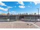 Tennis court with an open gate and neighborhood in the background at 8303 E Monterey Ave, Mesa, AZ 85209