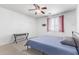 Bright bedroom with white walls, neutral carpet, ceiling fan and plantation shutters at 8720 N 182Nd Ln, Waddell, AZ 85355