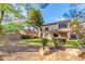 Lush backyard featuring green grass, shade trees, and a fountain at 1043 W Washington Ave, Gilbert, AZ 85233