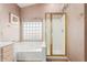 Bright bathroom with soaking tub with glass block window and separate shower at 1043 W Washington Ave, Gilbert, AZ 85233