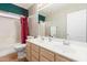 Bathroom featuring a double sink vanity, soaking tub, and a toilet at 1043 W Washington Ave, Gilbert, AZ 85233