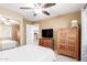 Bedroom featuring neutral walls, ceiling fan and mirrored closet at 1043 W Washington Ave, Gilbert, AZ 85233