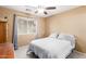 Bedroom featuring neutral walls, ceiling fan and a large window at 1043 W Washington Ave, Gilbert, AZ 85233