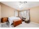 Comfortable bedroom with natural light, a cozy chair, and carpet flooring at 1043 W Washington Ave, Gilbert, AZ 85233