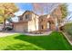 Two-story home with a two-car garage, green grass, and desert landscaping at 1043 W Washington Ave, Gilbert, AZ 85233