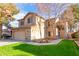 Two-story home with a two-car garage, green grass, and desert landscaping at 1043 W Washington Ave, Gilbert, AZ 85233