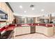 Open concept kitchen with stainless steel appliances and seamless transition to dining and living areas at 1043 W Washington Ave, Gilbert, AZ 85233