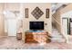 Entry with decorative wooden console table leading to staircase and kitchen at 1043 W Washington Ave, Gilbert, AZ 85233