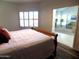 Bright bedroom featuring a comfortable bed and a window with plantation shutters at 10549 E Cedar Waxwing Dr, Sun Lakes, AZ 85248