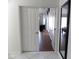 Open doorway into the primary bedroom showcasing wood flooring and a mirrored wall feature at 10549 E Cedar Waxwing Dr, Sun Lakes, AZ 85248