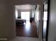 View into the bedroom, featuring wood floors and mirrored wall, enhancing the room's spaciousness at 10549 E Cedar Waxwing Dr, Sun Lakes, AZ 85248