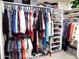 This organized walk in closet has clothing and shelving at 10549 E Cedar Waxwing Dr, Sun Lakes, AZ 85248