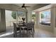 Dining area with a table, chairs, large windows, and a ceiling fan for a comfortable dining experience at 10549 E Cedar Waxwing Dr, Sun Lakes, AZ 85248