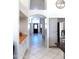 Bright hallway with tile floors, cabinets, and arched entrance to the main room at 10549 E Cedar Waxwing Dr, Sun Lakes, AZ 85248