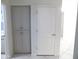 Hallway with storage cabinets and a white paneled door, seamlessly connecting spaces at 10549 E Cedar Waxwing Dr, Sun Lakes, AZ 85248