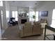 Inviting living room with a fireplace, plush seating, and ample natural light from shuttered windows at 10549 E Cedar Waxwing Dr, Sun Lakes, AZ 85248