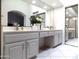 Bright bathroom featuring a dual sink vanity, light gray cabinets, and a large mirrored wall at 10549 E Cedar Waxwing Dr, Sun Lakes, AZ 85248