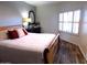 Bedroom with a comfortable bed, dresser with decorative mirror, and window shutters, creating a serene atmosphere at 10549 E Cedar Waxwing Dr, Sun Lakes, AZ 85248