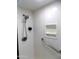 The bright white shower has a shower head with a chrome safety bar and shelf at 10549 E Cedar Waxwing Dr, Sun Lakes, AZ 85248