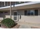 Charming condo entrance with a decorative wreath, storm door and green bushes at 10846 N Fairway E Ct, Sun City, AZ 85351