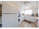 Bright kitchen featuring white appliances, a garden window, and ceiling fan at 10846 N Fairway E Ct, Sun City, AZ 85351