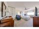 Bright main bedroom with a ceiling fan, carpeted floor, and furniture at 10846 N Fairway E Ct, Sun City, AZ 85351