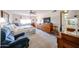 Bright main bedroom featuring carpet floors, ceiling fan, and furniture at 10846 N Fairway E Ct, Sun City, AZ 85351