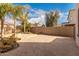 Spacious backyard features a stone patio, desert landscaping, block wall fence, and a beautiful fire pit at 11128 E Segura Ave, Mesa, AZ 85212