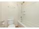 Bright bathroom featuring a white tiled shower over tub and a standard toilet at 11128 E Segura Ave, Mesa, AZ 85212