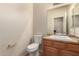 Cozy bathroom with granite vanity top, tile flooring, and a framed mirror at 11128 E Segura Ave, Mesa, AZ 85212