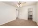 Neutral-toned bedroom with a ceiling fan, and access to a walk-in closet at 11128 E Segura Ave, Mesa, AZ 85212