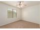 Bright bedroom with a ceiling fan and large window at 11128 E Segura Ave, Mesa, AZ 85212