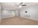 Neutral bonus room with wall mounted entertainment center, ceiling fan, and carpeted floors at 11128 E Segura Ave, Mesa, AZ 85212