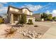 Charming two-story home showcasing stone accents, a two-car garage, and low-maintenance landscaping at 11128 E Segura Ave, Mesa, AZ 85212